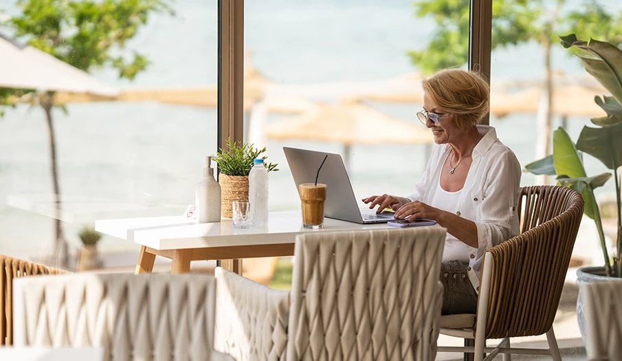 a woman sitting at a table with a laptop