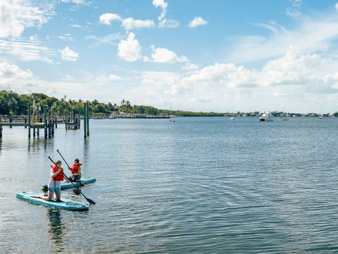 people on a paddle board on a lake
