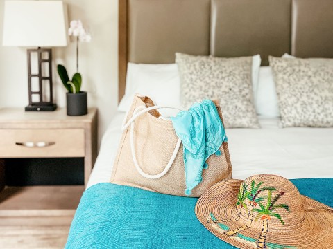 a bag and hat on a bed