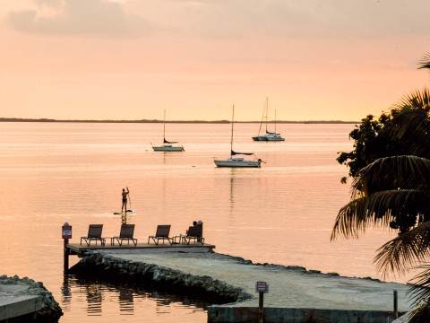 a dock with a couple of sailboats in the water