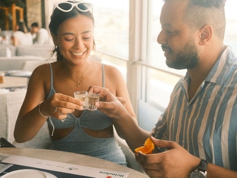 a man and woman holding glasses