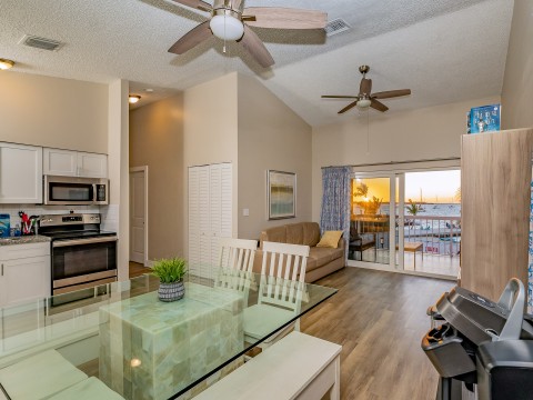 a living room with a glass table and a fireplace