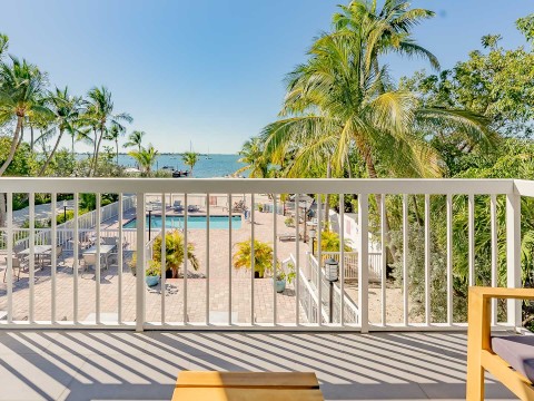 a deck with a pool and palm trees