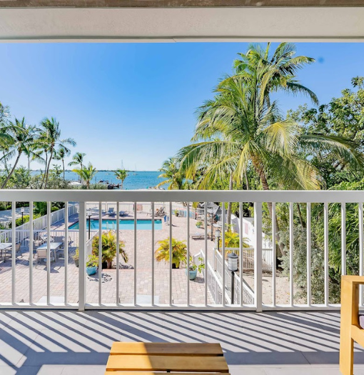 a balcony with a view of the ocean and a pool