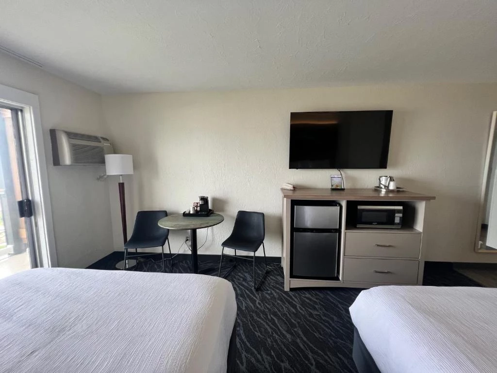a room with two beds and a television