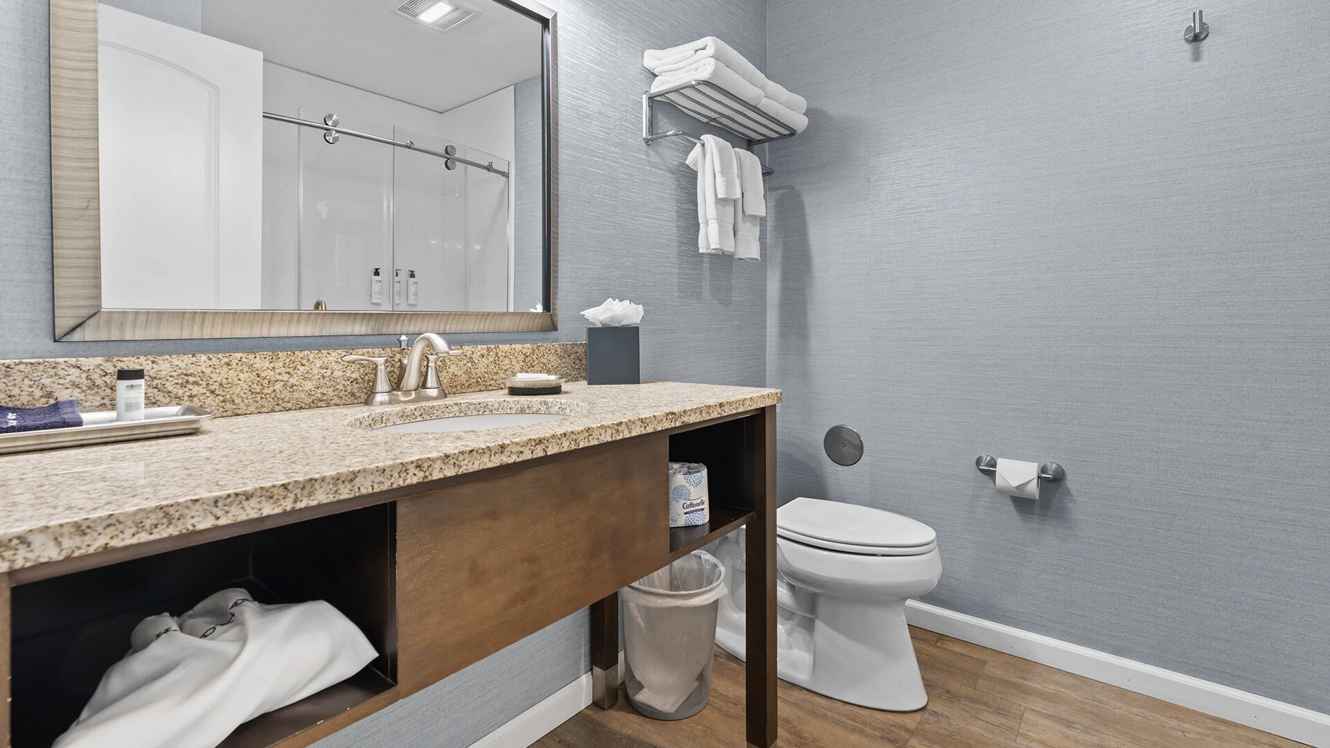 a bathroom with a marble countertop and a mirror