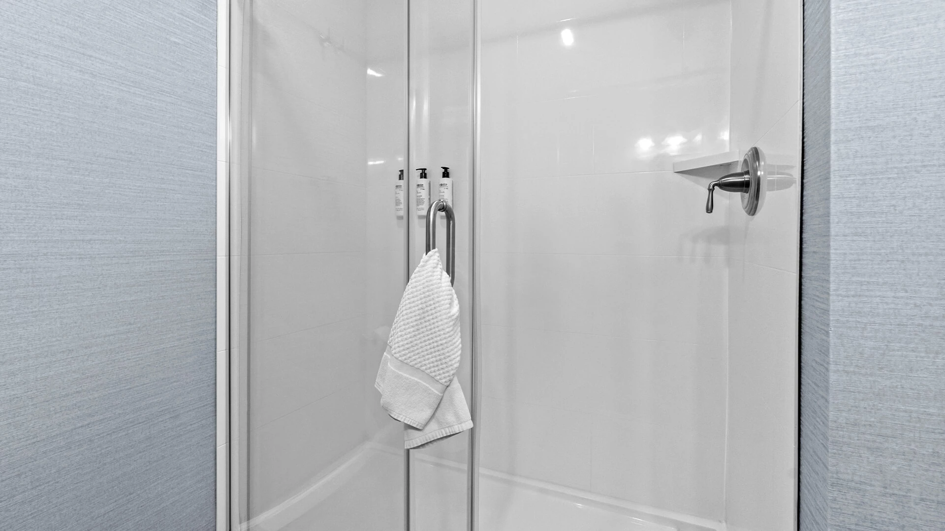 a shower with a towel on the handle