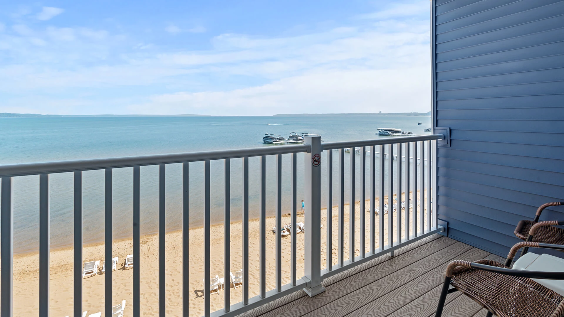a deck with a railing overlooking a beach