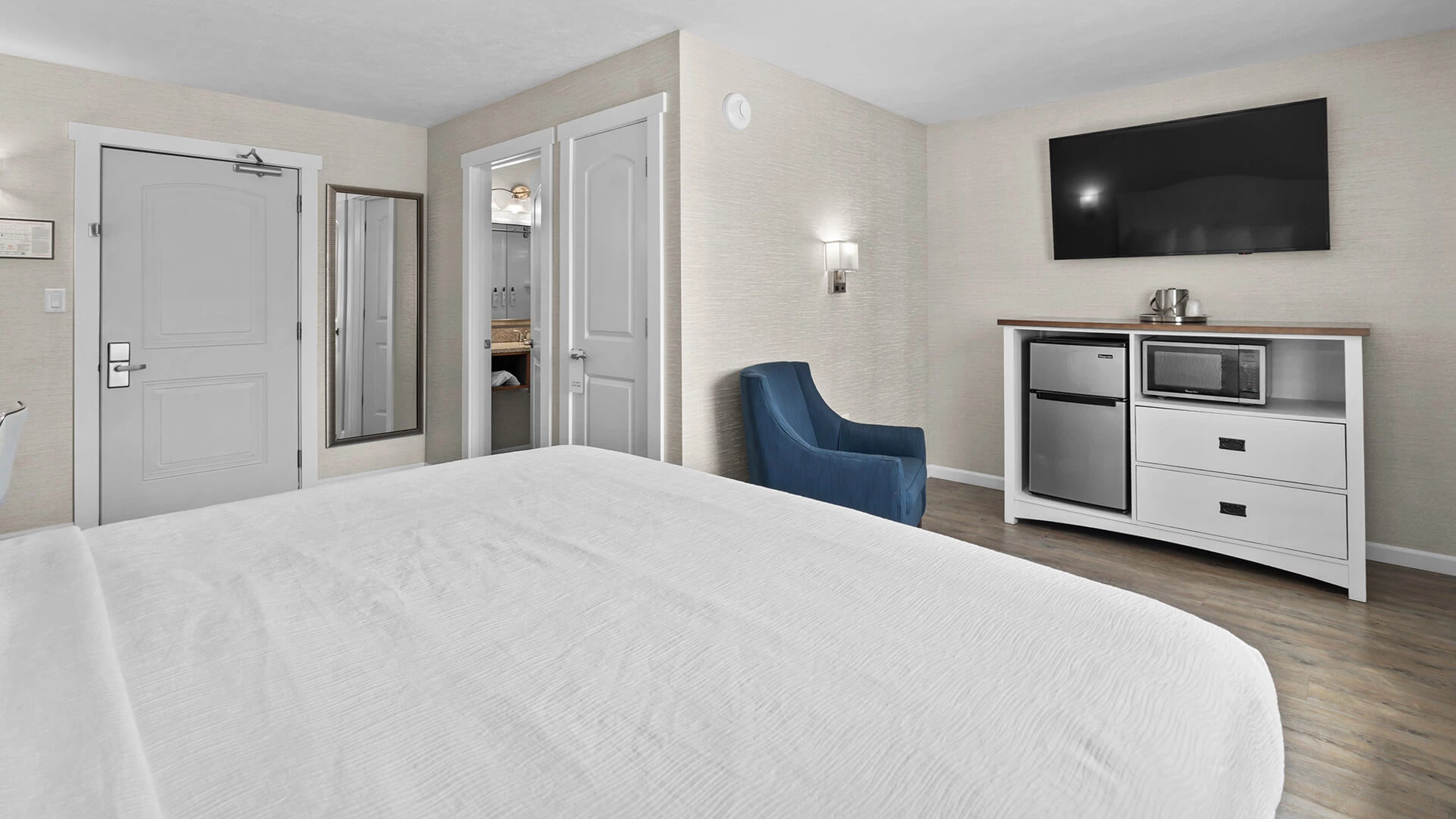 a room with a bed and a television