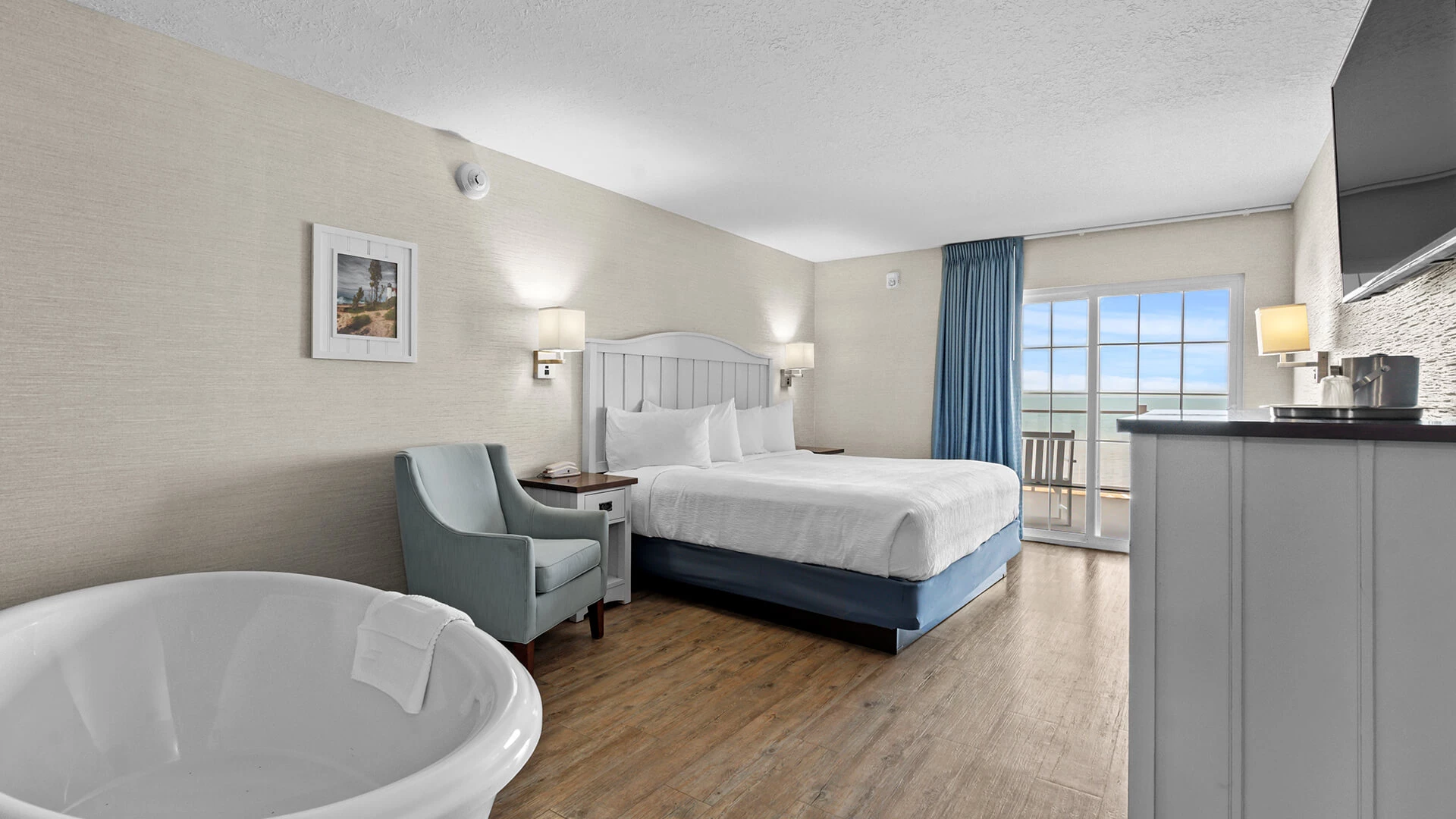 a room with a large bed and a tub