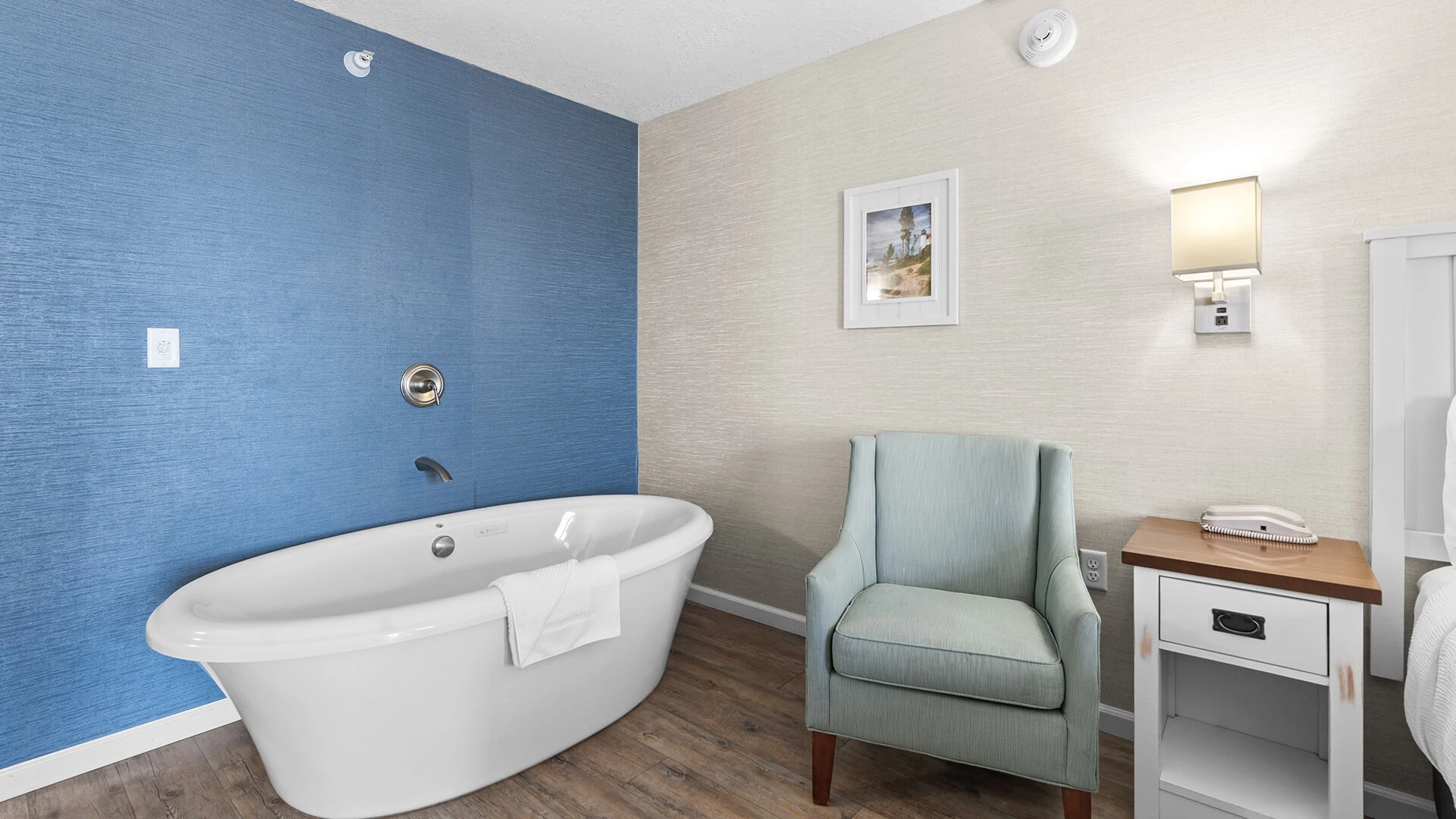 a bathroom with a tub and chair