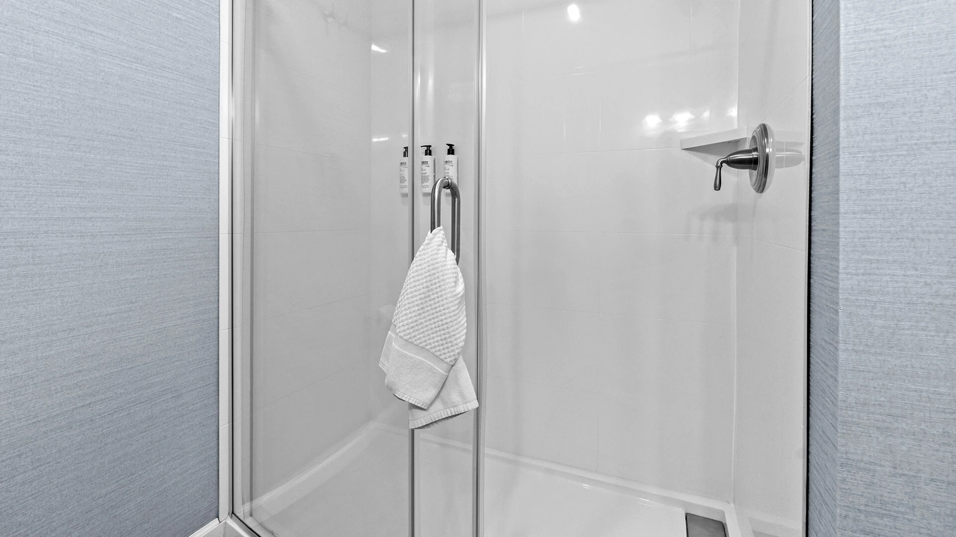a shower with a towel on the handle