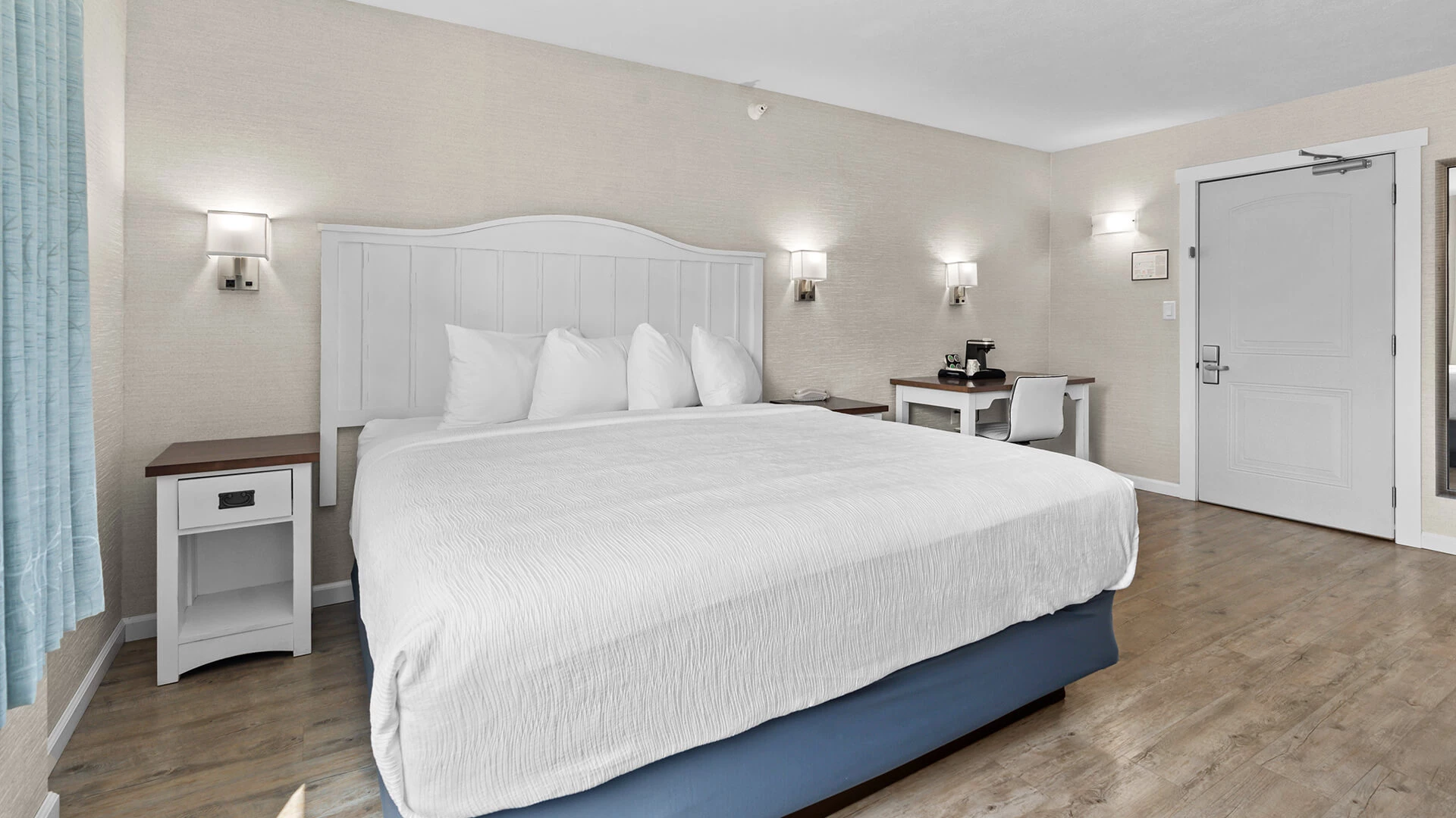 a bed with a desk and lamp