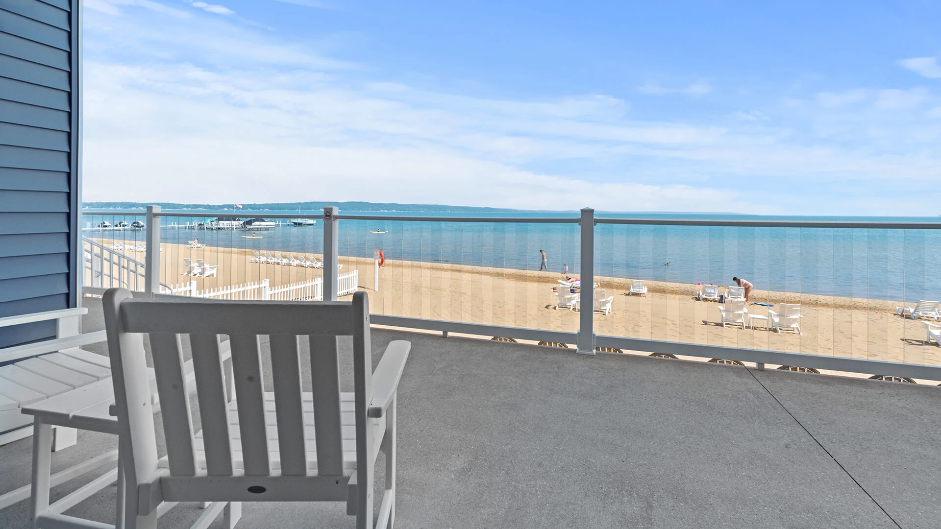 a chair on a balcony overlooking a beach