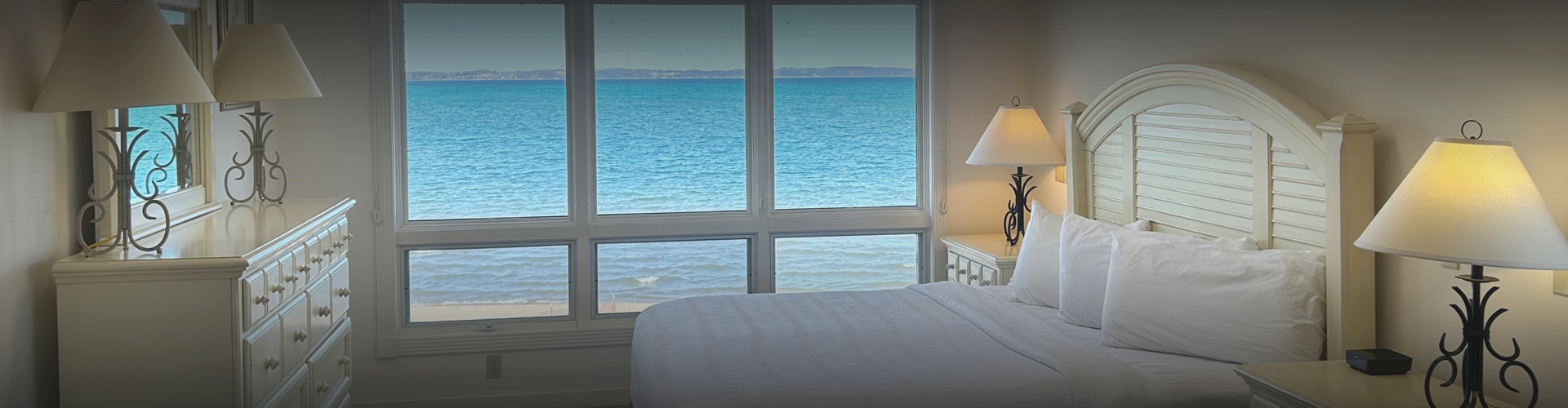 a bedroom with a view of the ocean