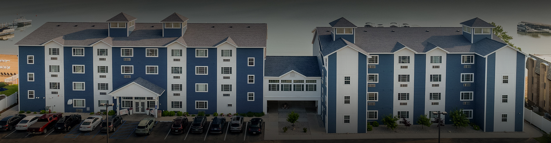 a blue and white building with parking lot