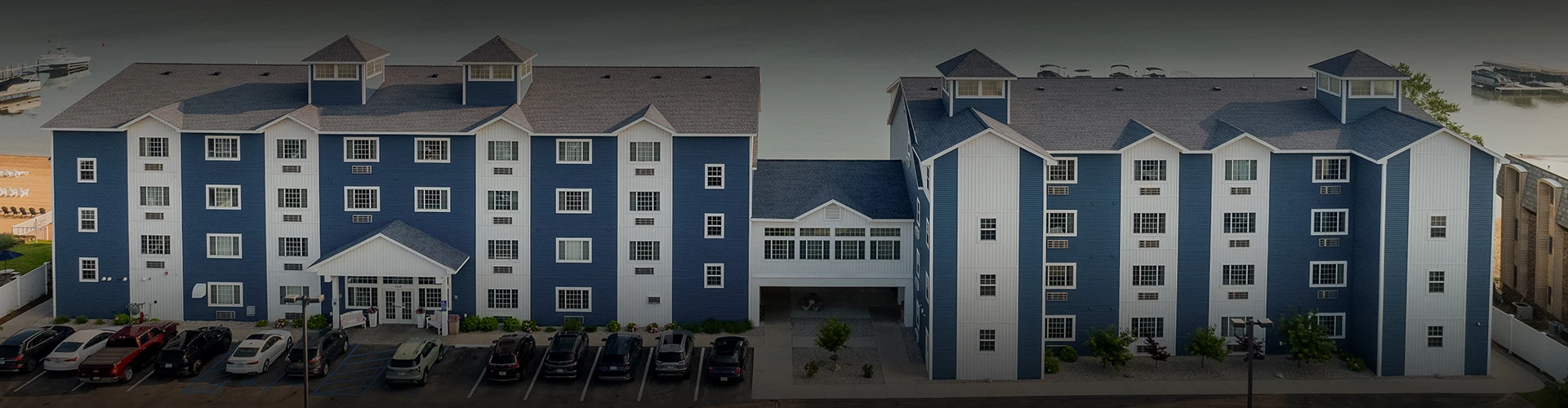 a blue and white building with parking lot