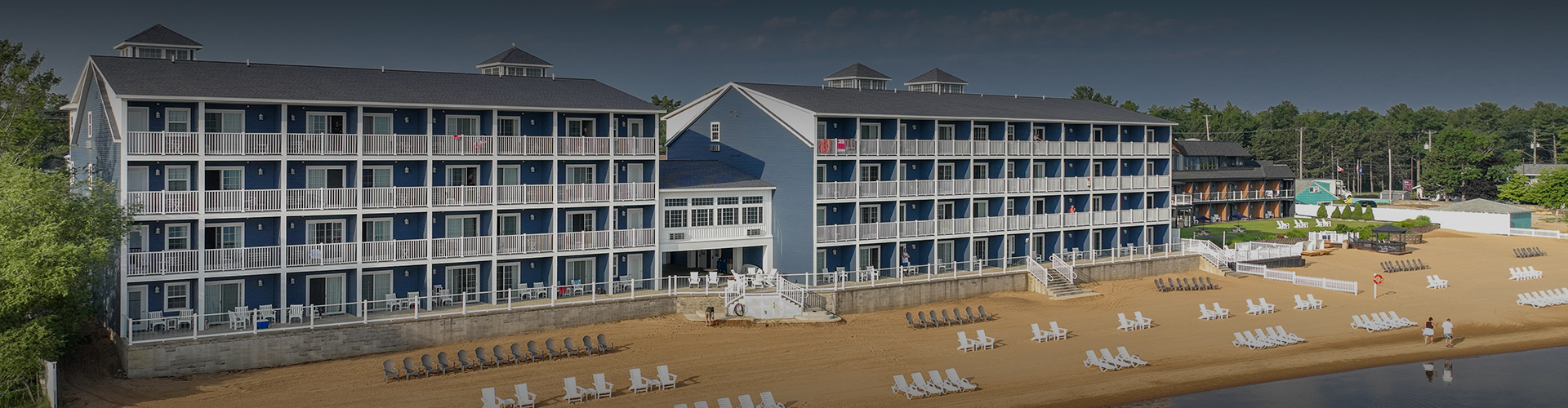 a beach with a blue building and chairs
