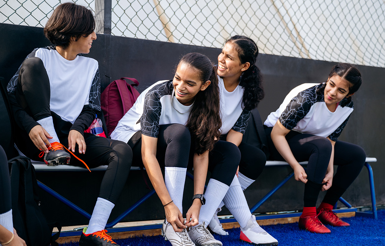 a group of girls sitting on a bench
