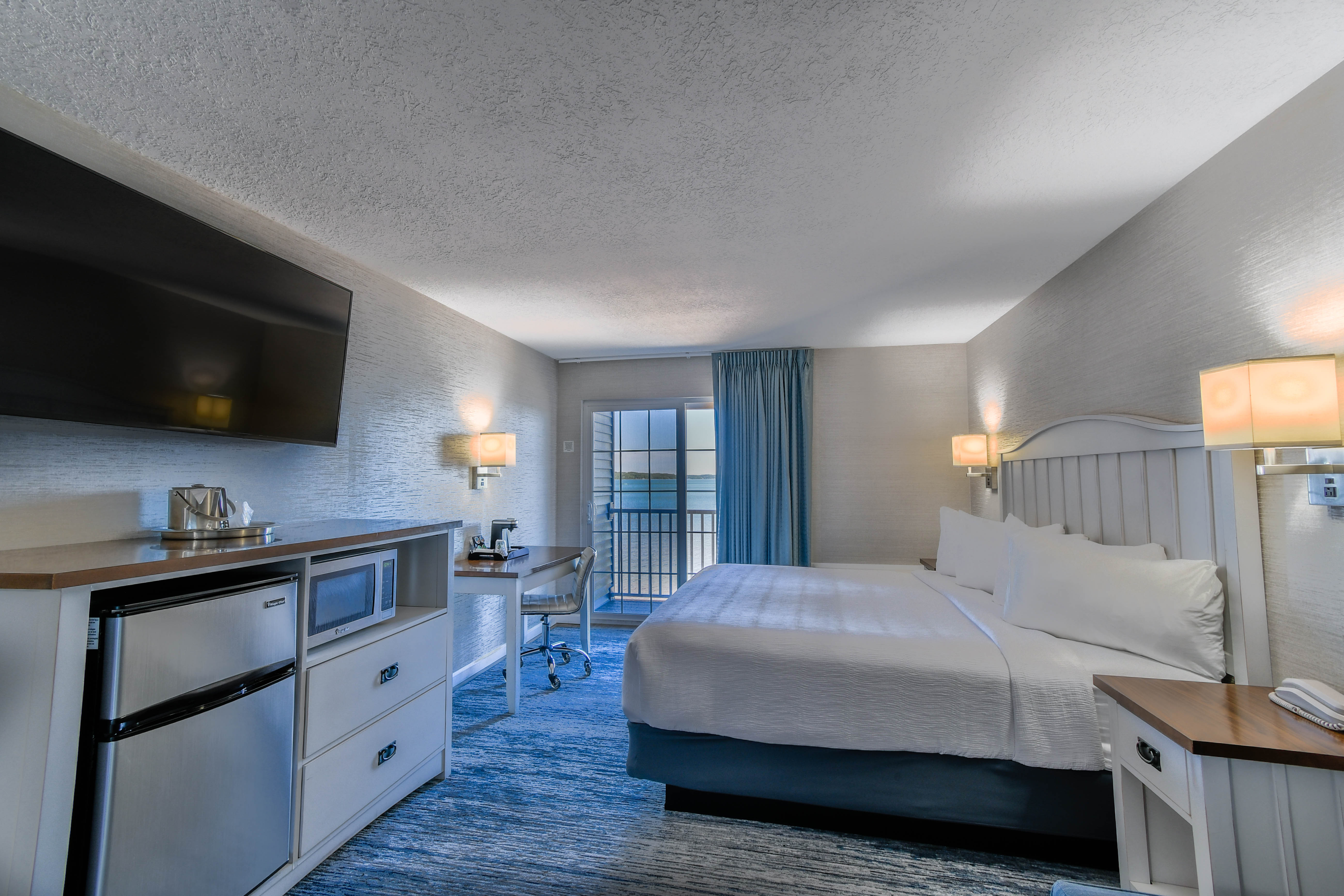 a room with a bed and a television