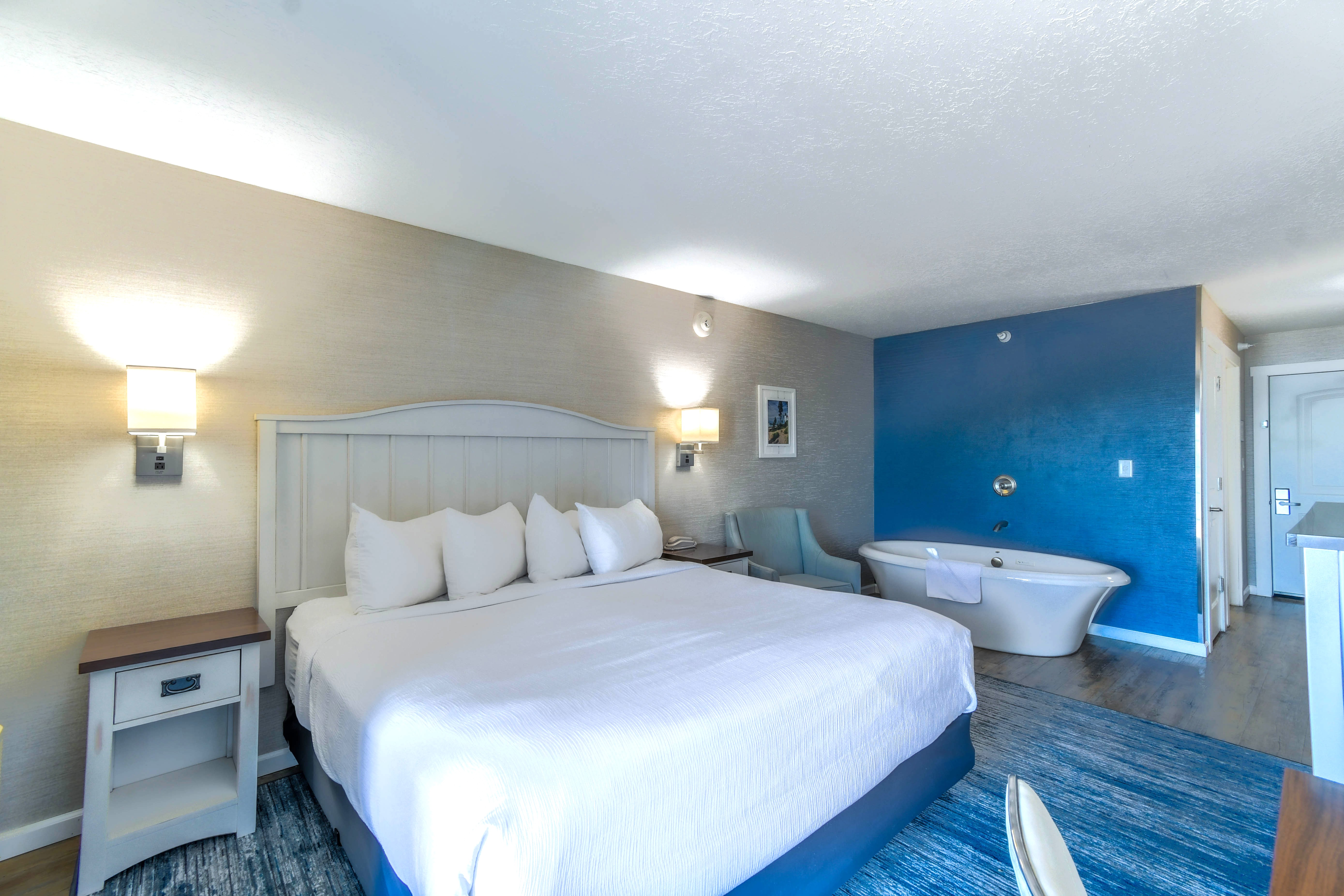a room with a bed and tub