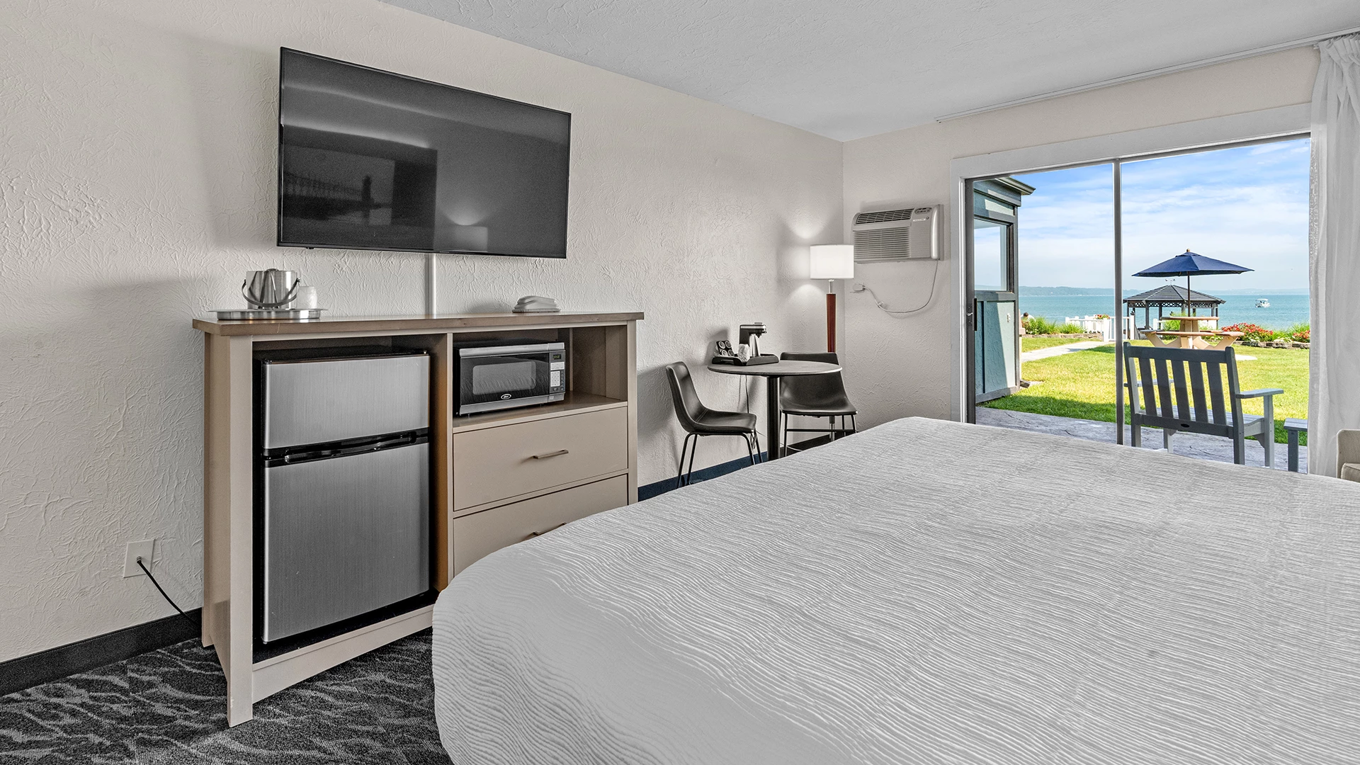 a room with a bed and a television