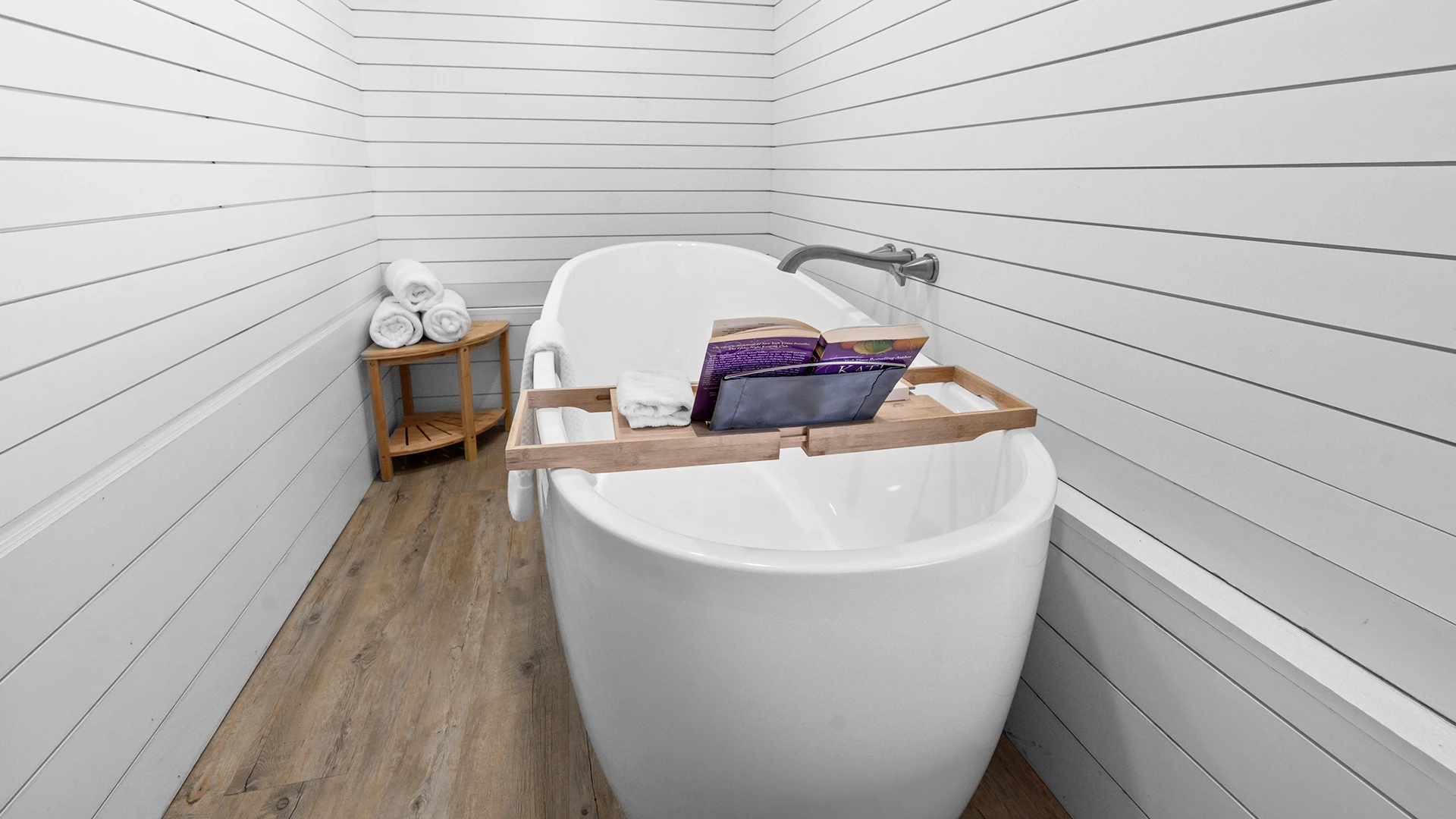 a bathtub with a shelf on it