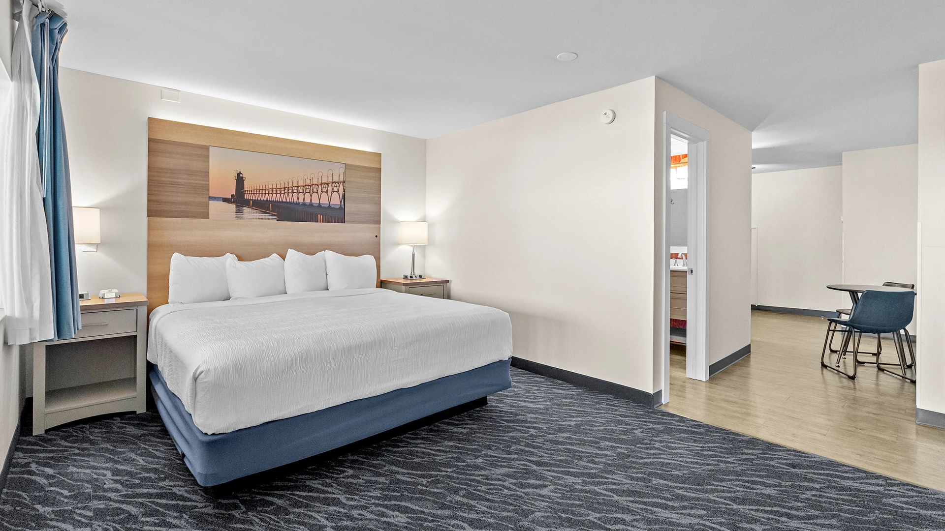 a room with a bed and a picture of a bridge