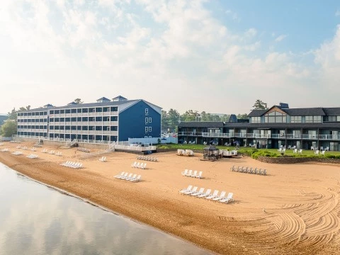a beach with chairs and a building