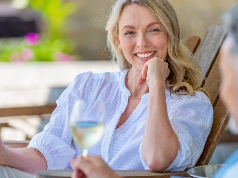 a woman sitting in a chair with a glass of wine