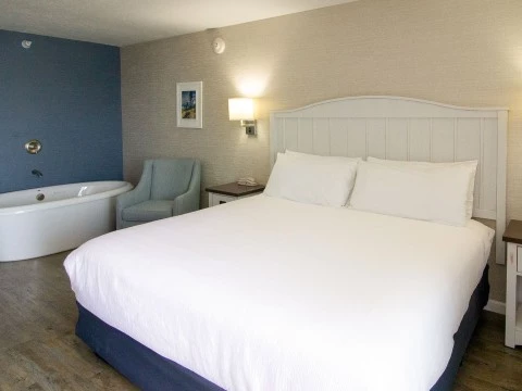 a bed with a tub and a lamp