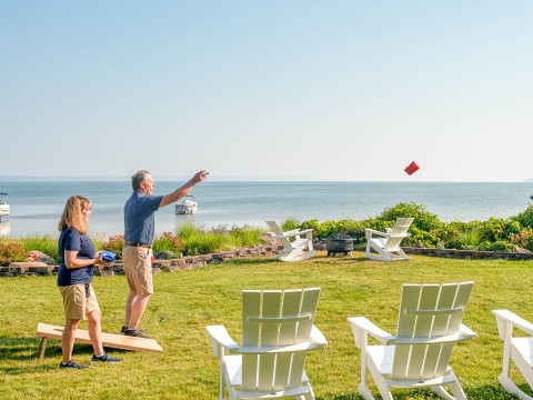a man and woman throwing a red object in the air