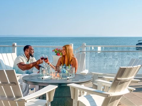 a man and woman sitting at a table with wine glasses