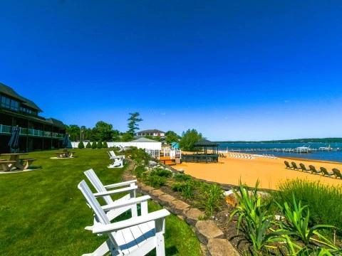 a lawn with chairs and a beach