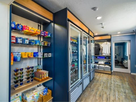 a store with shelves of drinks and sunglasses