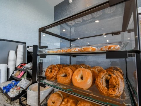 a display case of bagels and pastries