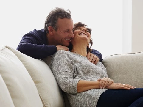 a man and woman sitting on a couch