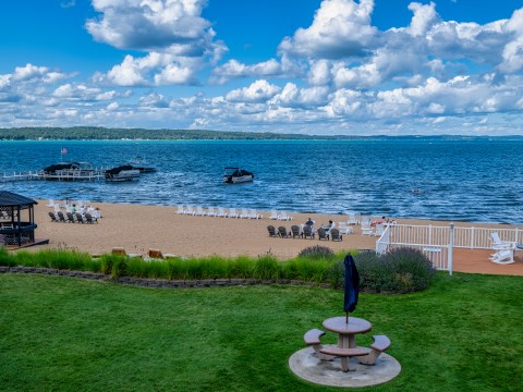a beach with a picnic table and chairs on the beach