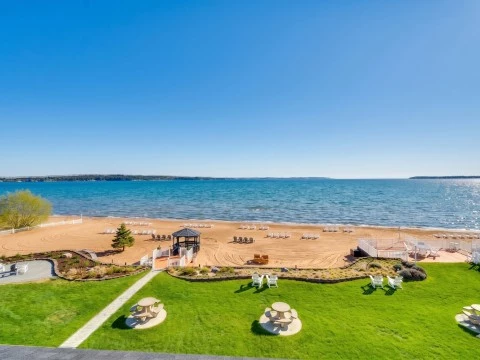 a beach with chairs and tables