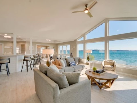a living room with a large window overlooking the water