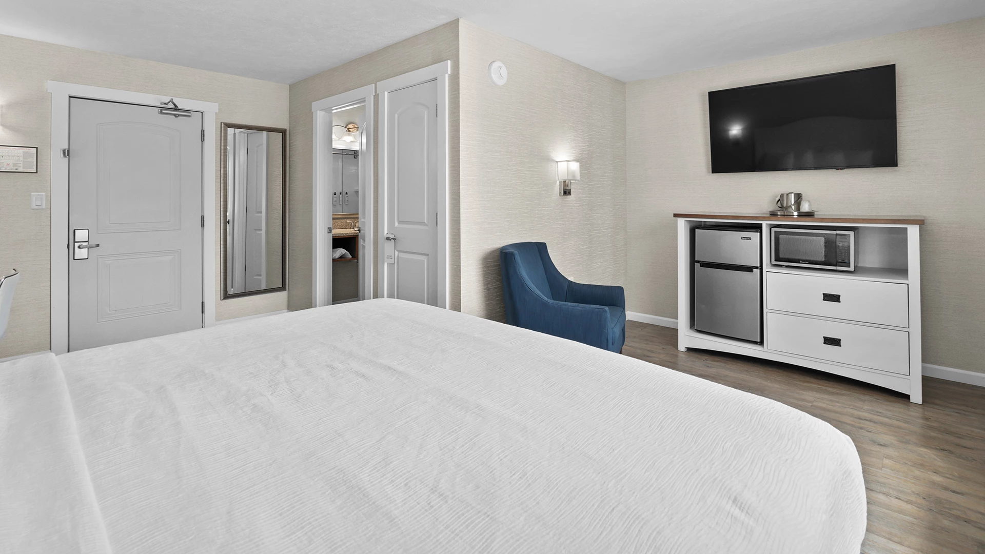 a room with a bed and a television