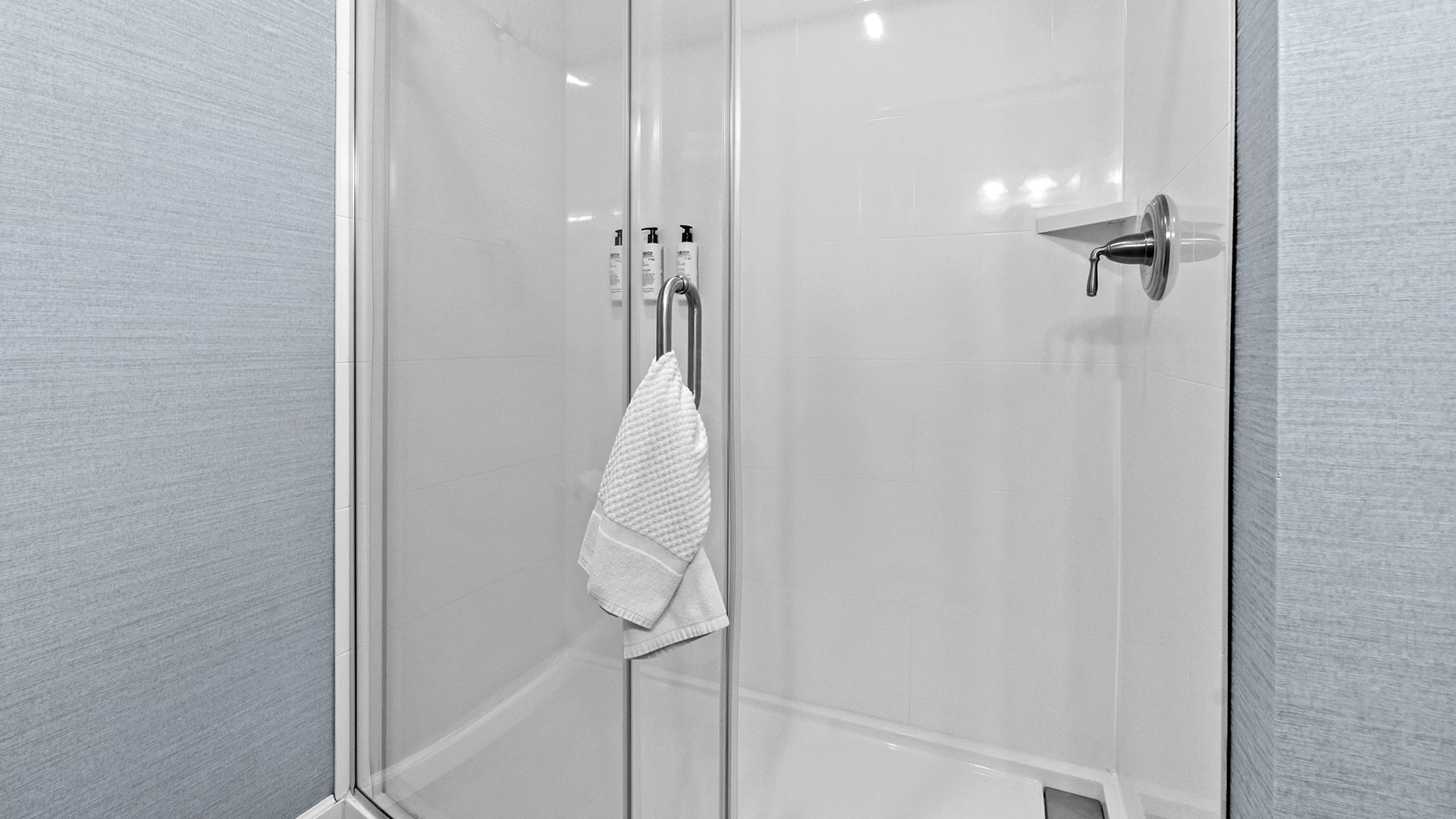 a shower with a towel on the handle