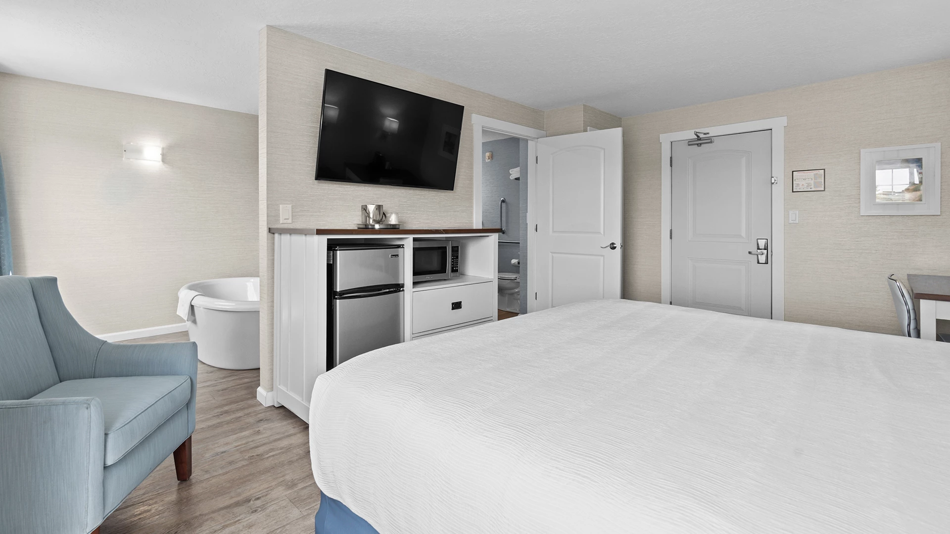 a bedroom with a tv and a tub