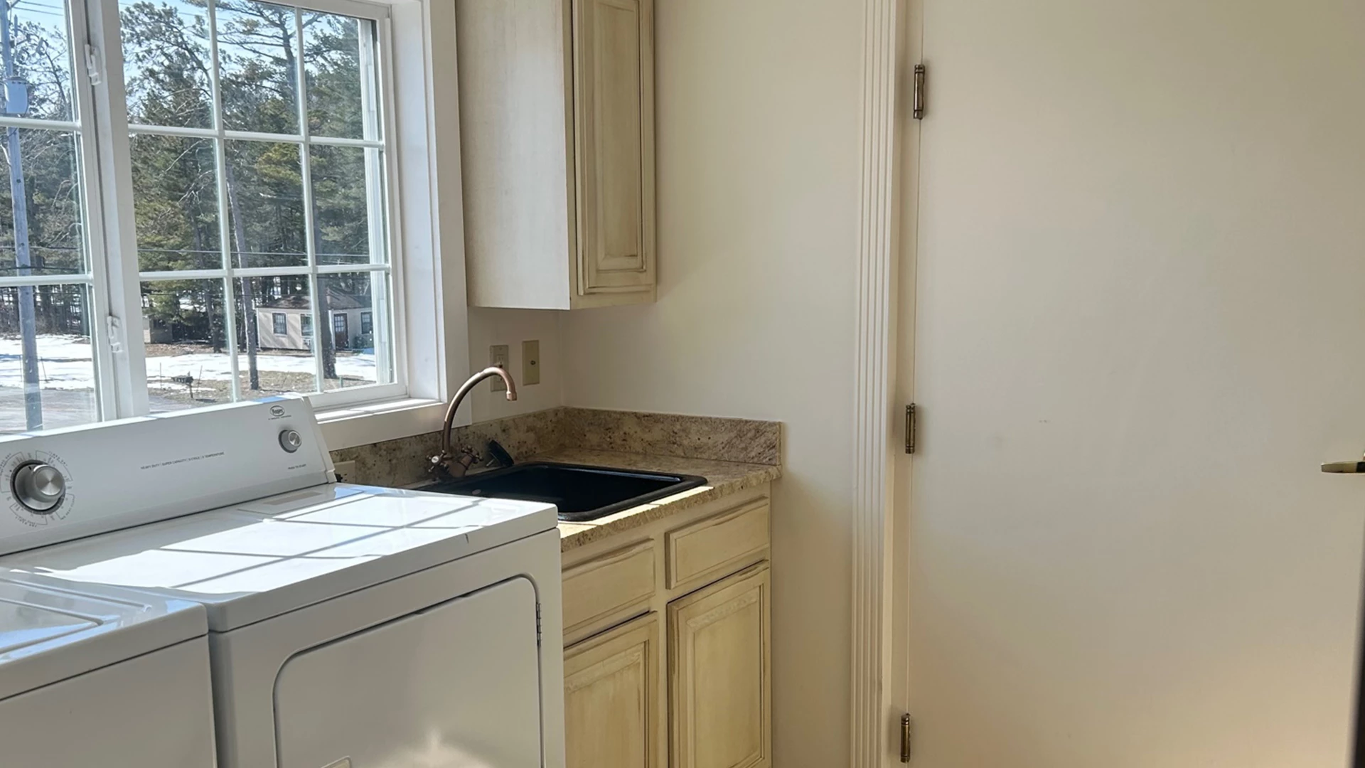a kitchen with a washing machine and a sink