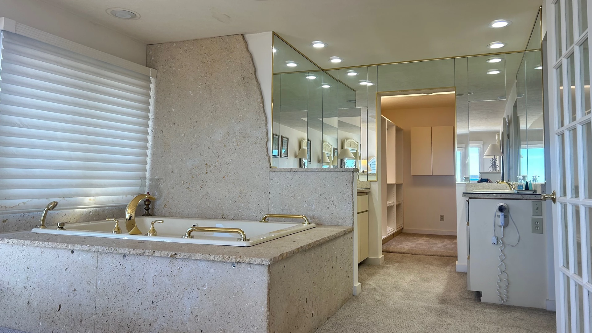 a bathroom with a large bathtub and a mirror