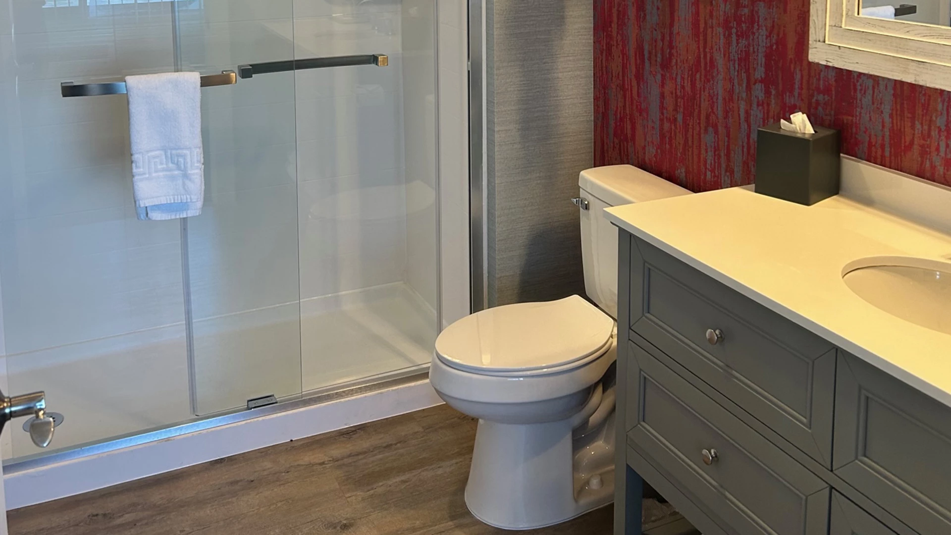 a bathroom with a shower and toilet