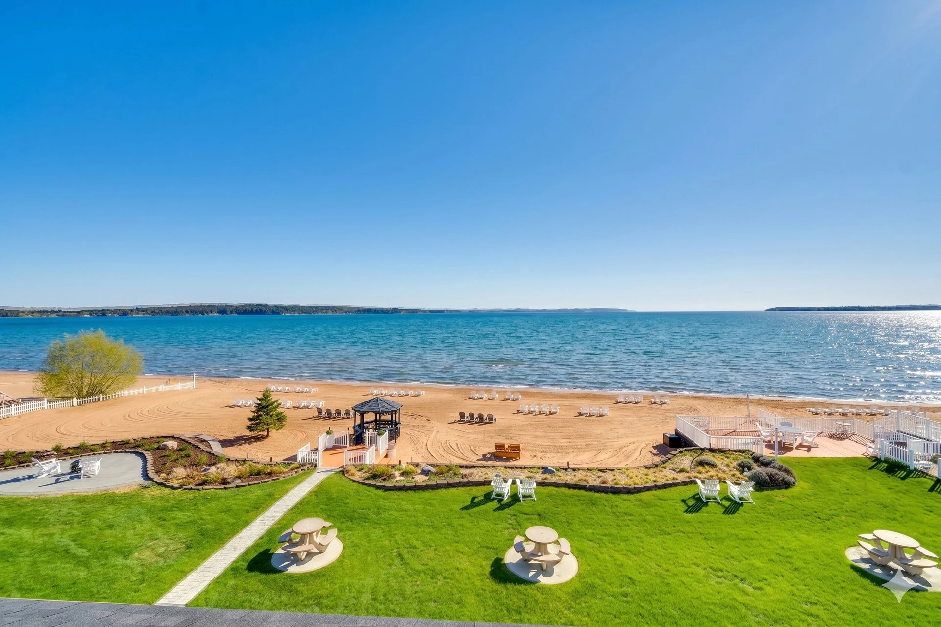 a beach with chairs and tables