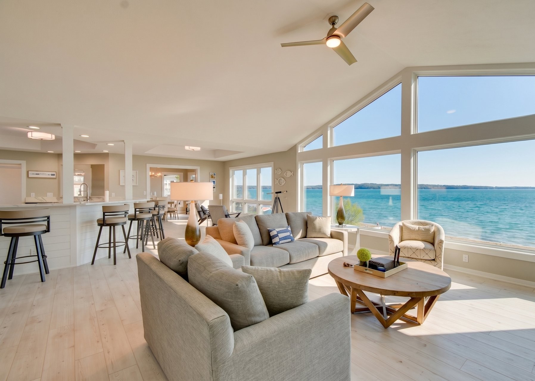 a living room with a large window overlooking the water