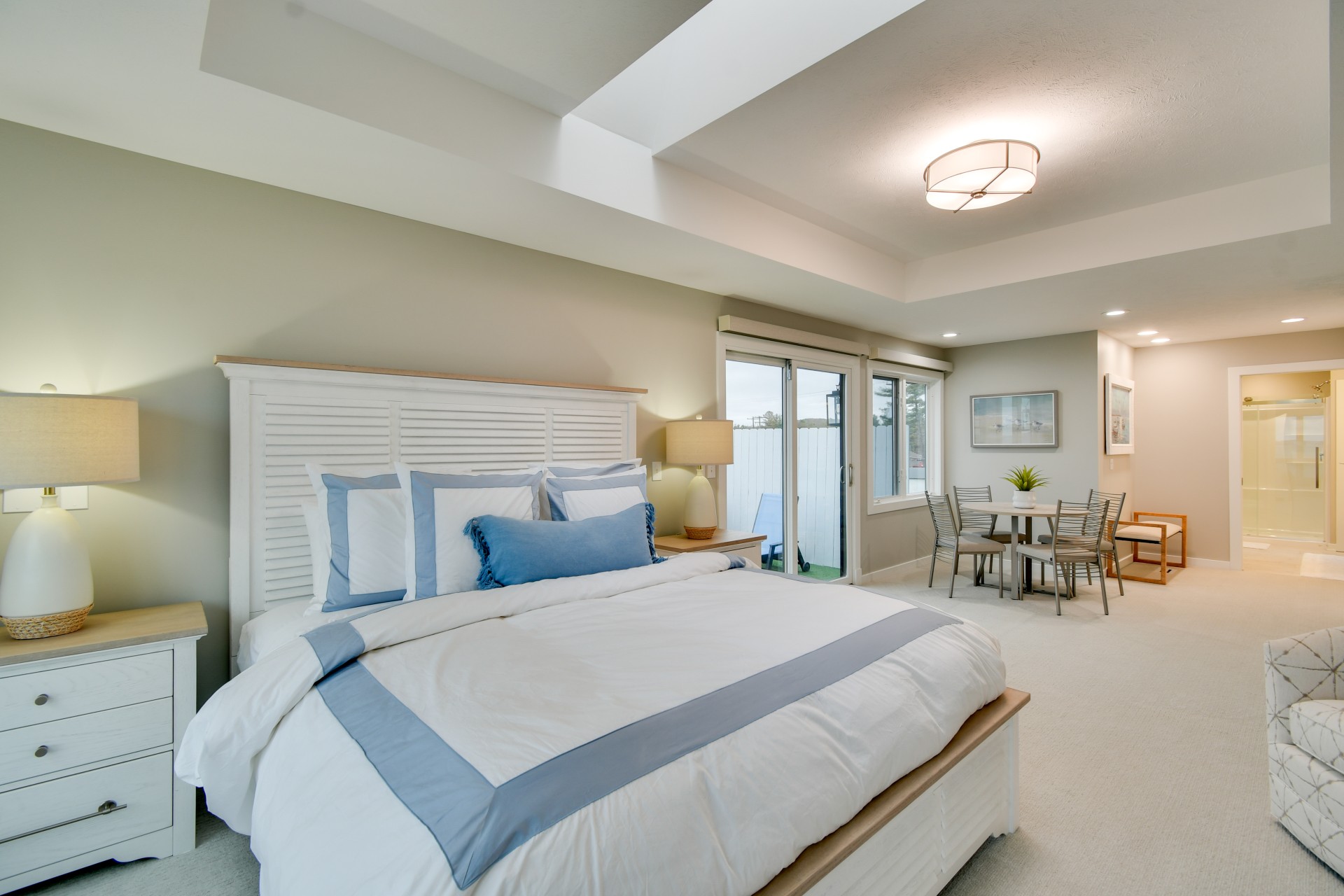 a bedroom with a large bed and a dining table