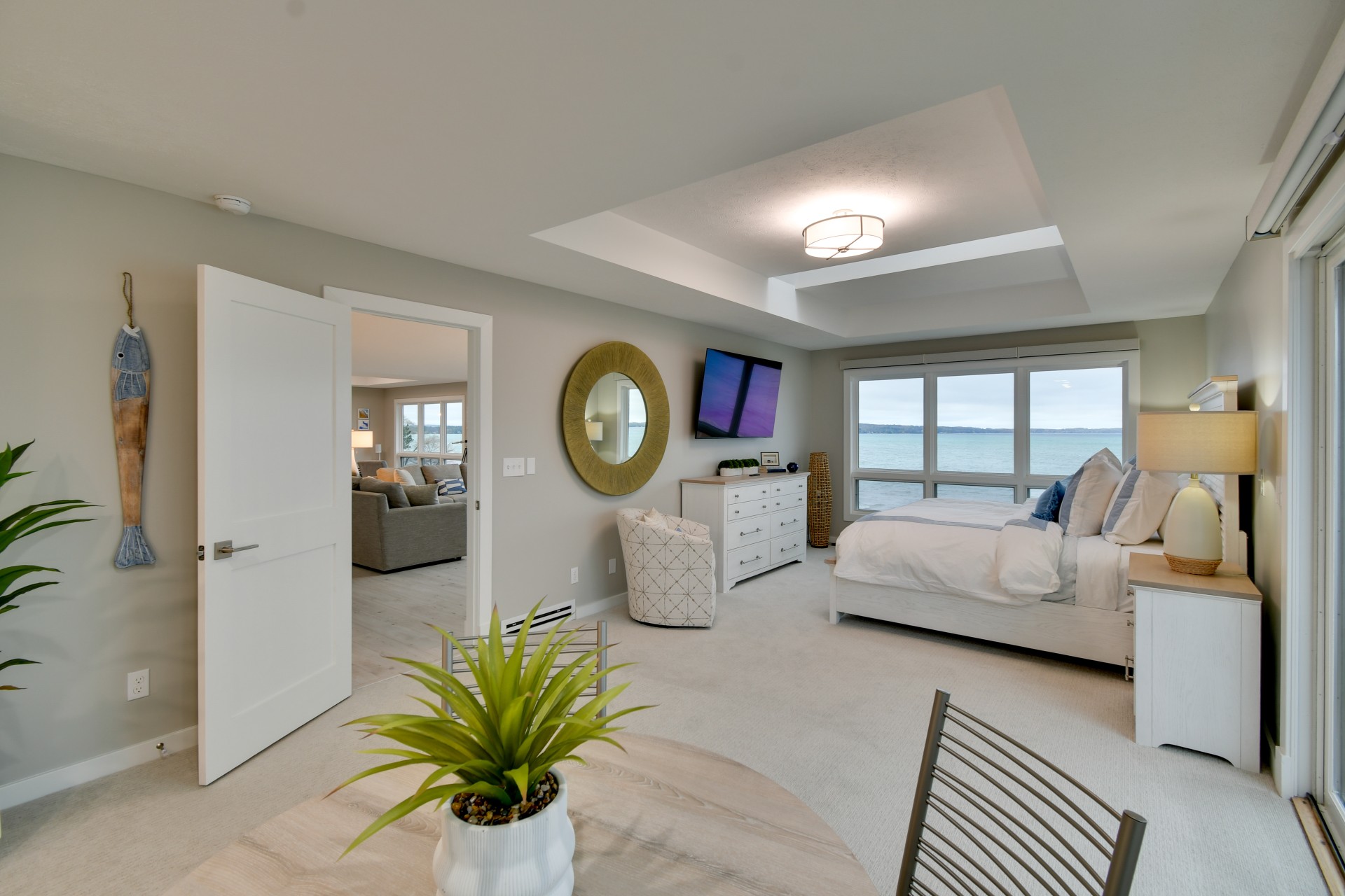 a bedroom with a large window overlooking the ocean